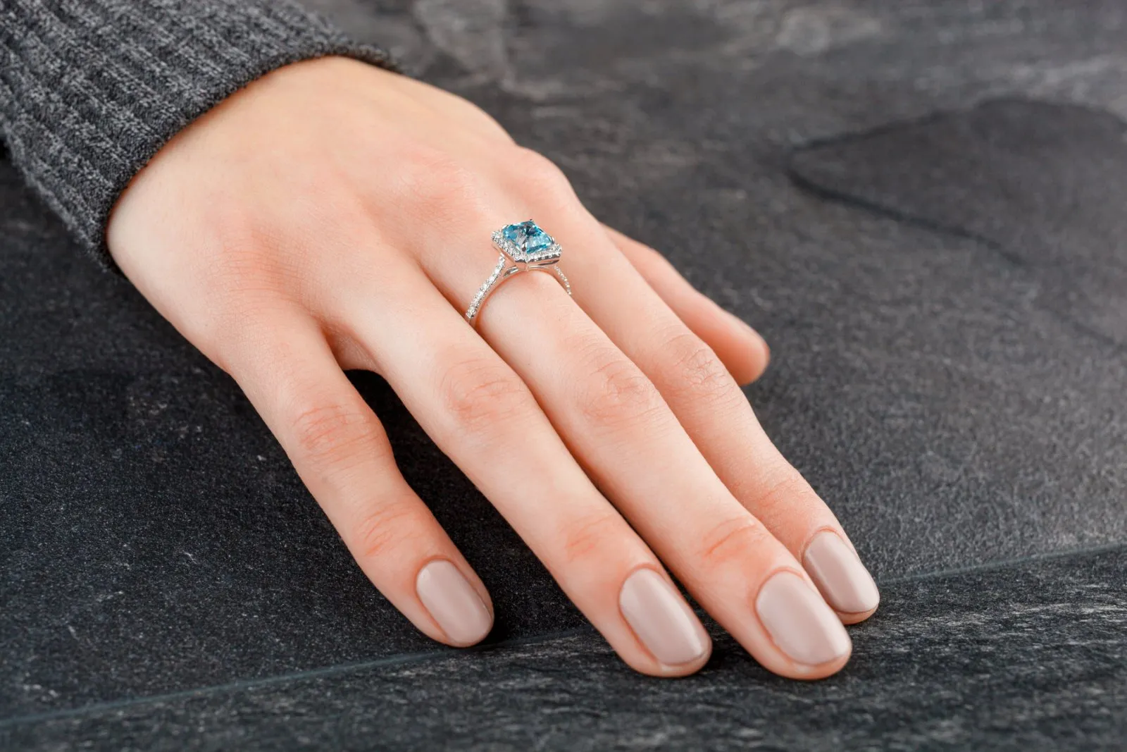 A hand wearing a gold ring