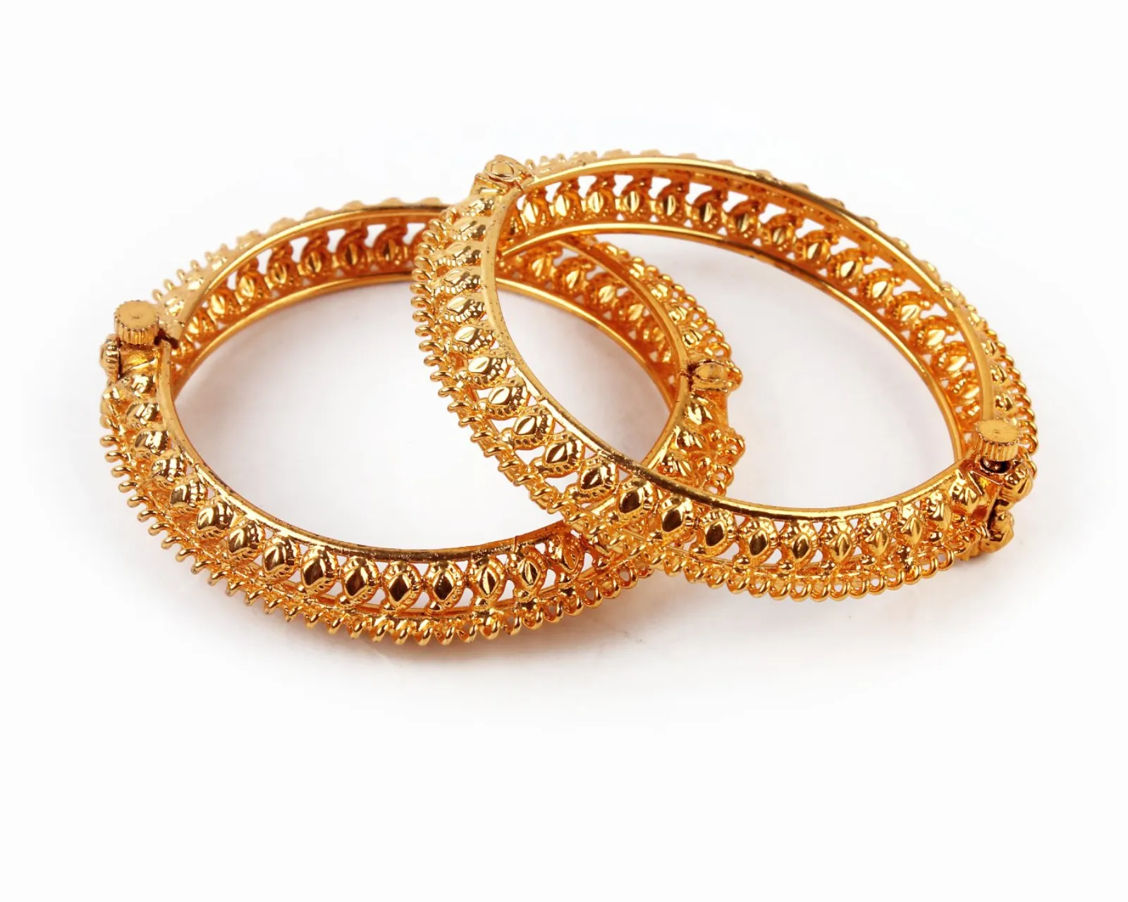 Gold bangles on white